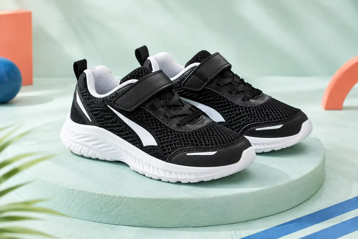Paire de baskets de running Puma pour enfant, en maille noire avec des détails blancs